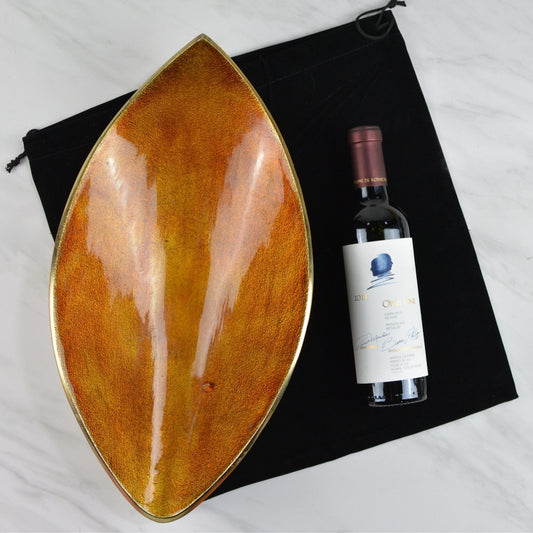 375 ml bottle of Opus One wine, wood and gold tray and black velvet gift bag